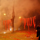 A man runs after lighting firecrackers to celebrate the start of the Chinese New Year in Beijing.